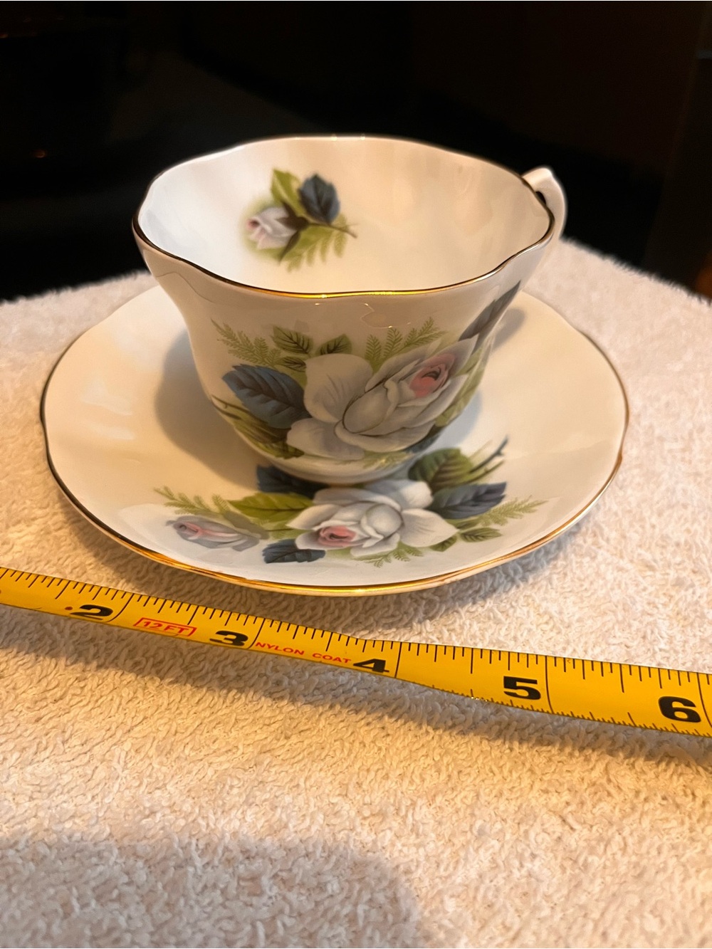 White Floral Porcelain Teacup and Saucer with Gold Trim